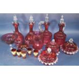 A varied selection of Cranberry glass including wine pitchers, bowls comport, gilded glasses and a