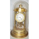 A late 19th century brass 400 day anniversary clock with reeded column supports, painted dial, brass