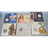 A collection of thirty three brilliant uncirculated sets of £5 coins, covering a variety of