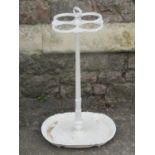 19th century cast iron stick stand, the central pedestal supporting four rings on a shaped drip