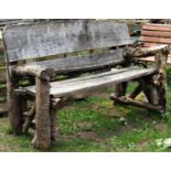 A weathered rustic rough hewn wooden garden bench, 155 cm wide approximately