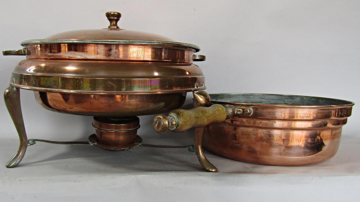 A copper tripod casserole with burner, a copper saucepan, a large copper Middle Eastern tray and two