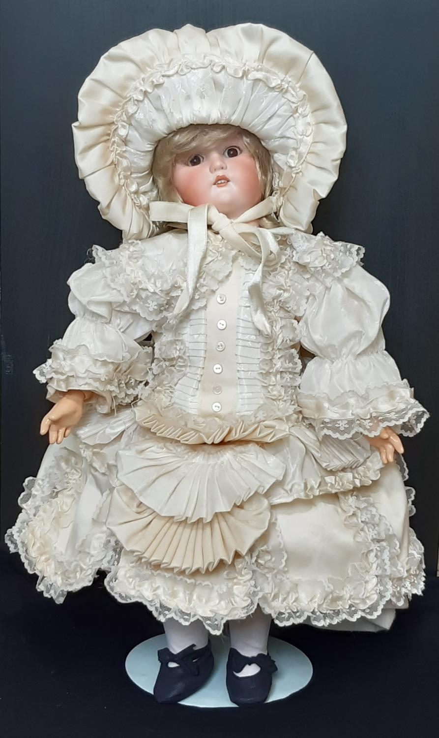 Early 20th century bisque head doll with closing brown eyes, open mouth with teeth and jointed