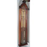 A Victorian Fitzroy Barometer housed in a walnut case, set beneath an architectural pediment with