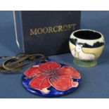 A Moorcroft Pottery egg cup decorated with sheep, a cow and a goat, 5cm tall, with original box,