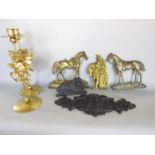 A Victorian cast iron flat recumbent lion 16cm wide, two flat brass horses, a gilt finish flat