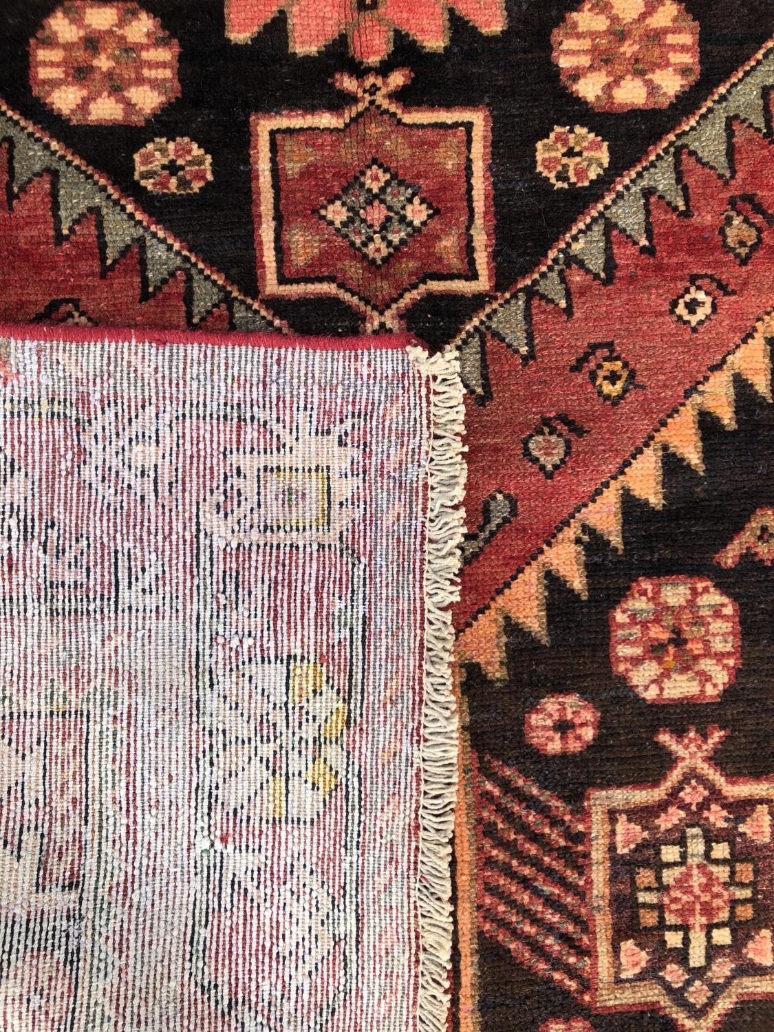 A Zanjan rug with a central geometric motif with radiating stylised flowers, 215cm x 130cm approx - Image 2 of 2