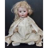 A small bisque head child doll by Schoenau & Hoffmeister circa 1920, with 5 piece bent limb