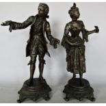 Two spelter figures of a French 18th century man and a woman, both 36cm approx and a brass meat