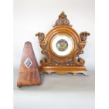 A Victorian oak mantel barometer with carved floral mounts, 34cm w x 39cm h, and Wittner mahogany