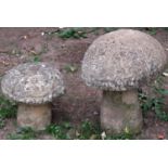 A weathered buff coloured composition stone garden ornament in the form of a toadstool, 50 cm high