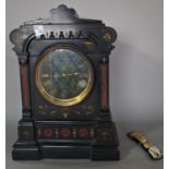 A mid-19th century black slate and marble mantle clock with gothic detail, gilded highlights and