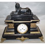 A mid-19th century black slate and polished brass mantle clock with pseudo Egyptian detail