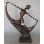 An Art Deco bronze effect statuette of a woman holding a pose.