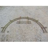 A 19th century iron door arch with hooped rails with simple scrolled ends 250 cm wide x 135 cm