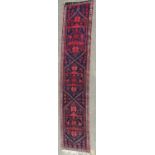 A Middle Eastern runner with a repeating pink star pattern on a blue ground, 280cm x 58cm approx