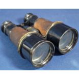 A cased pair of WWI military issue binoculars with original heavy leather outer case, H. Whisson and