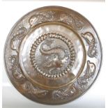 J F Pool of Hayle Cornwall Arts and Crafts copper embossed charger with a central dolphin within a