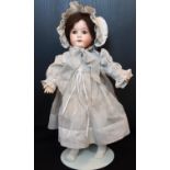 A William Goebel bisque head doll, early 20th century, with brown eyes, open mouth with teeth and