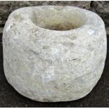 A primitive circular carved natural stone mortar 30 cm diameter x 22 cm high
