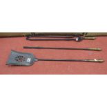 A set of three Victorian brass and steel fire irons, shovel, poker and tongs, the cast brass handles