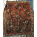 An antique Tekke carpet with five central elephant foot medallions in a faded rusty red, 200cm x