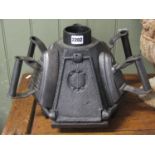 A small vintage cast iron tortoise/turtle stove of hexagonal form for heating/warming flat irons (
