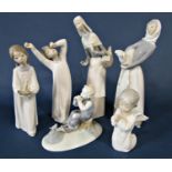 A collection of Lladro figures to include a young girl holding a lamb and a further of a young