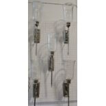 Five chromium plated candle wall sconces with glass hurricane shades, 72 cm