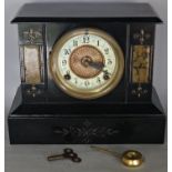 A Victorian black slate and marble mantle clock with decorated dial by the Ansonia Clock Co