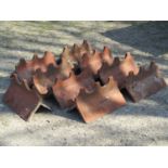 Nine reclaimed weathered terracotta ridge tiles with repeating pattern, indistinctly stamped