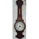 An Edwardian oak aneroid barometer with carved detail, porcelain dial and presentation plate