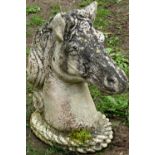 A weathered cast composition stone garden ornament/pier finial in the form of a horses head 48 cm