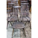 A set of five (4&1) Ercol dark stained elm and beechwood high tapered stick back dining chairs