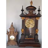 A late 19th century German mantle clock, the case with column supports and further decorated finish,