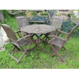 A stained and weathered folding hardwood garden table with octagonal slatted panelled top 102 cm