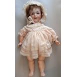 Early 20th century French bisque head smiling child doll by SFBJ, with jointed composition body,