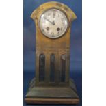 An Arts & Crafts style mantle clock set in an anodised case enclosing three bevelled edge plate
