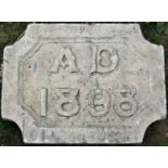 A weathered carved natural stone date stone 'AD 1898' 50 cm wide x 38 cm high x 10 cm thick