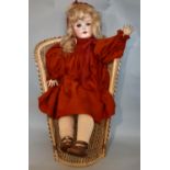 Large early 20th century bisque head child doll by Ernst Heubach, with jointed composition body,