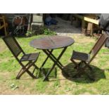 A contemporary stained hardwood folding hardwood table of circular form with slatted top together