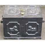 A 19th century cast iron strong box with drop side carrying handles and repeating recumbent lion