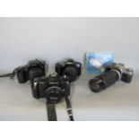 Photographic equipment, including a Canon AV-1 camera with a Hoya zoom lens, a Nikon F-301 camera, a