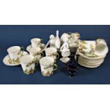 A Limoges France set of ten coffee cans and fourteen saucers with colourful decorative thistle