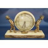 A mid 20th century onyx mantle clock, the casework supported by two gilded cherubs