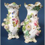 Collection of floral encrusted ceramics comprising a pair of Coalbrookdale porcelain vases with gilt