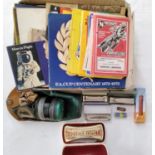 A mixed collection of items to include a WW II civilian gas mask, speedway programs, collector
