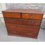 A Georgian oak country made bedroom chest of two short over three long graduated drawers raised on