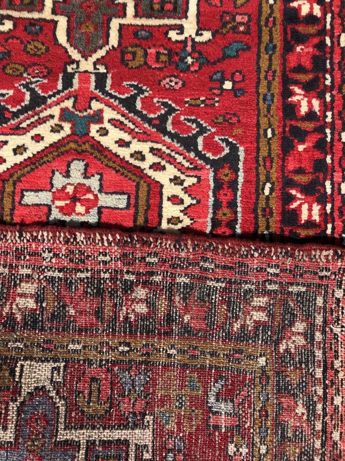 A Heriz runner with a single row interlocking shaped medallions on a predominantly red ground, 275cm - Image 2 of 2