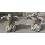 A pair of weathered partially painted cast composition stone garden ornaments/pier cap finials in
